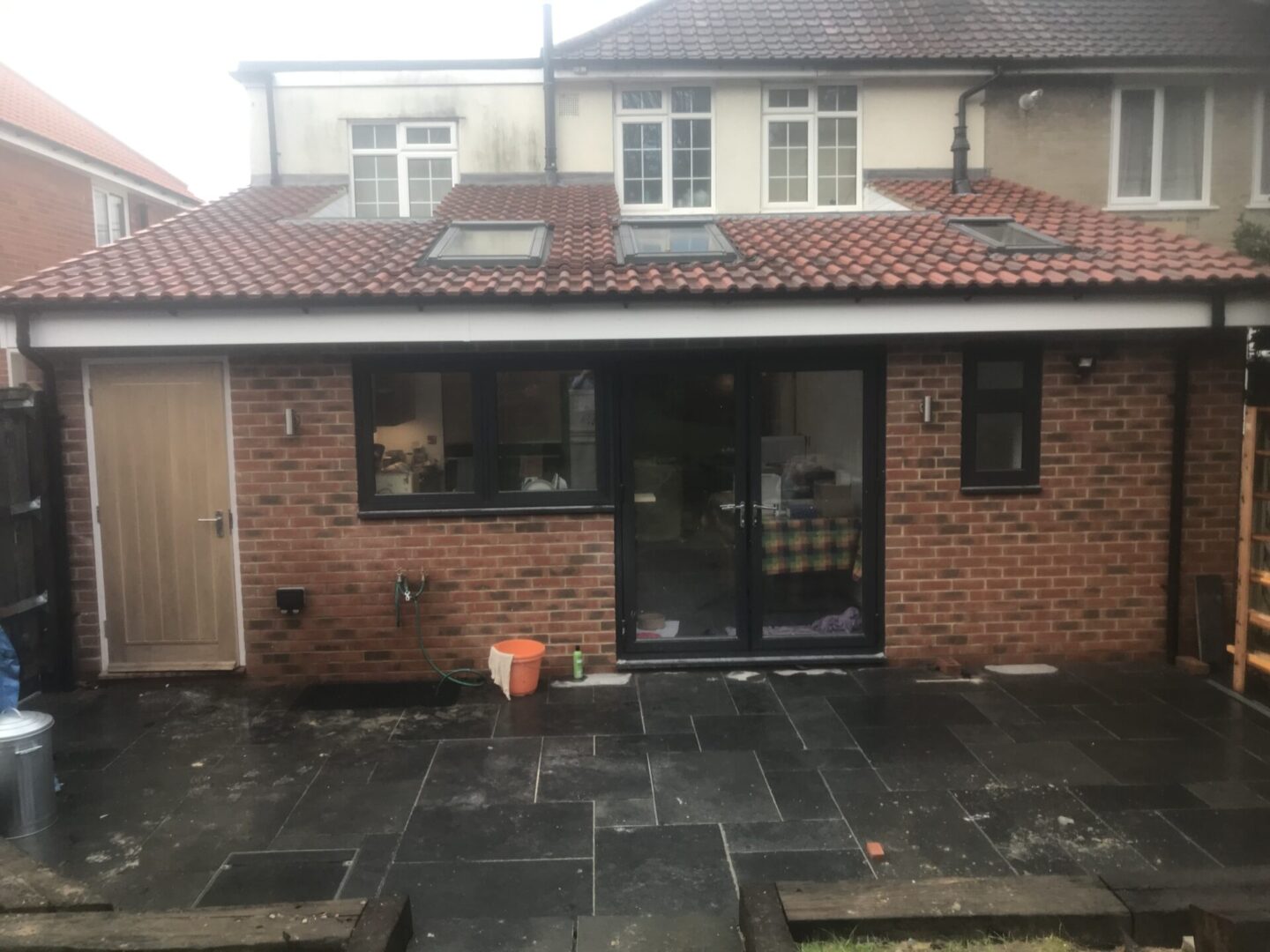 extension with roofing and brick walls