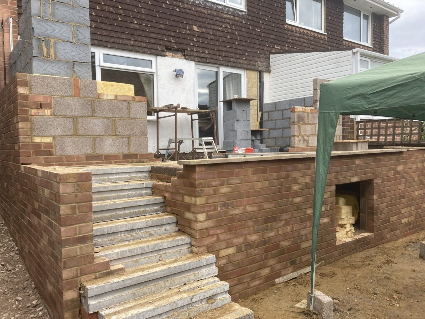 new stair way to porch in backyard with brick structures